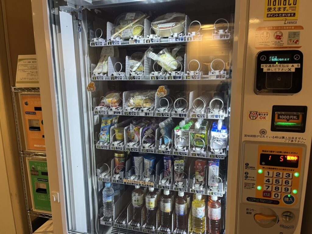 聖路加国際病院のセブン自販機に並ぶサンドイッチやおにぎりなどの軽食